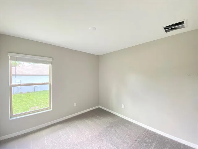 an empty room with closet area