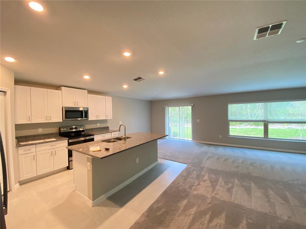 2530 Southwest 167th Loop Ocala, FL 34473 - Photo 2 of 31 a kitchen with stainless steel appliances granite countertop a stove a sink and a refrigerator