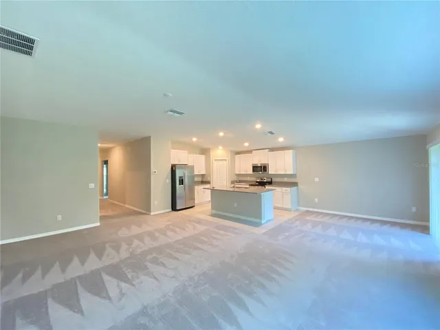 a view of kitchen with kitchen island sink and stove