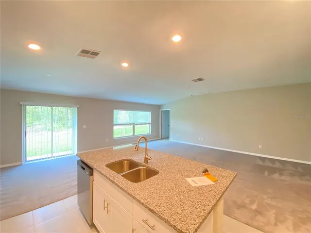 a kitchen with sink cabinets and window