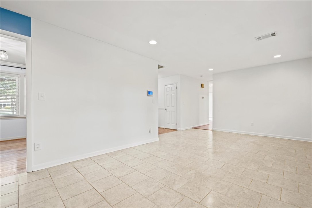 16 State Rd S-23-429 Greenville, SC 29609 - Photo 9 of 34 Gleaming tile floors and crisp white walls define this open, airy living space.