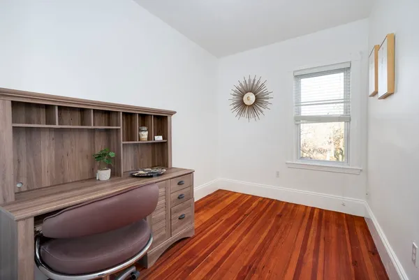 a room with wooden floor and furniture