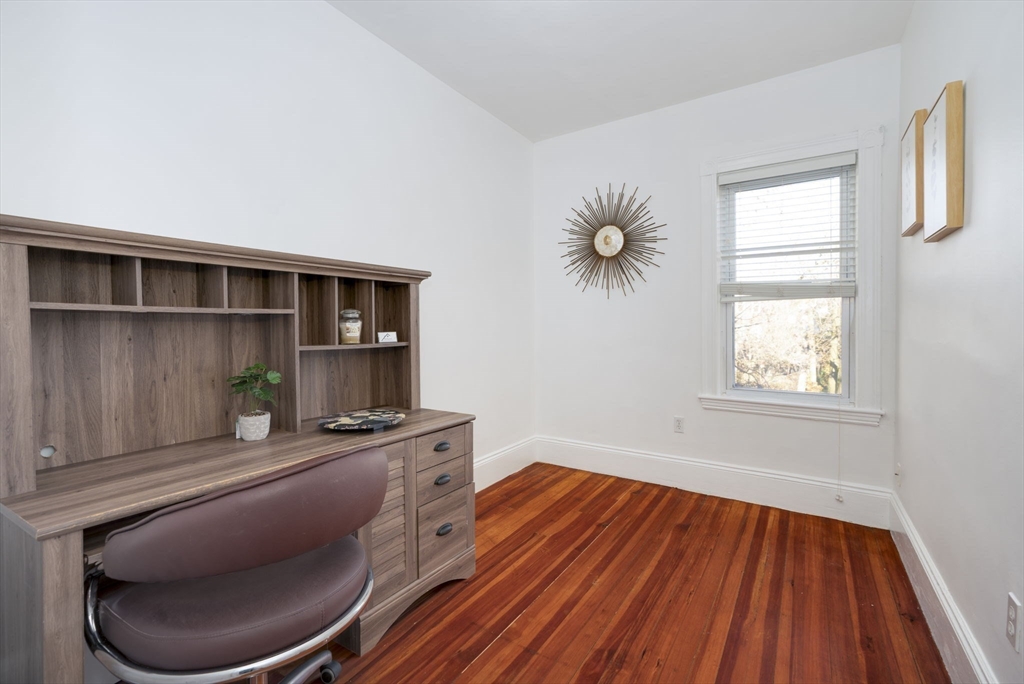 122 Brook Road, Unit 2 Quincy, MA 02169 - Photo 7 of 11 a room with wooden floor and furniture