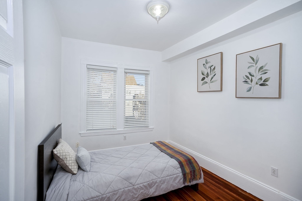 122 Brook Road, Unit 2 Quincy, MA 02169 - Photo 8 of 11 a bedroom with a bed and a window