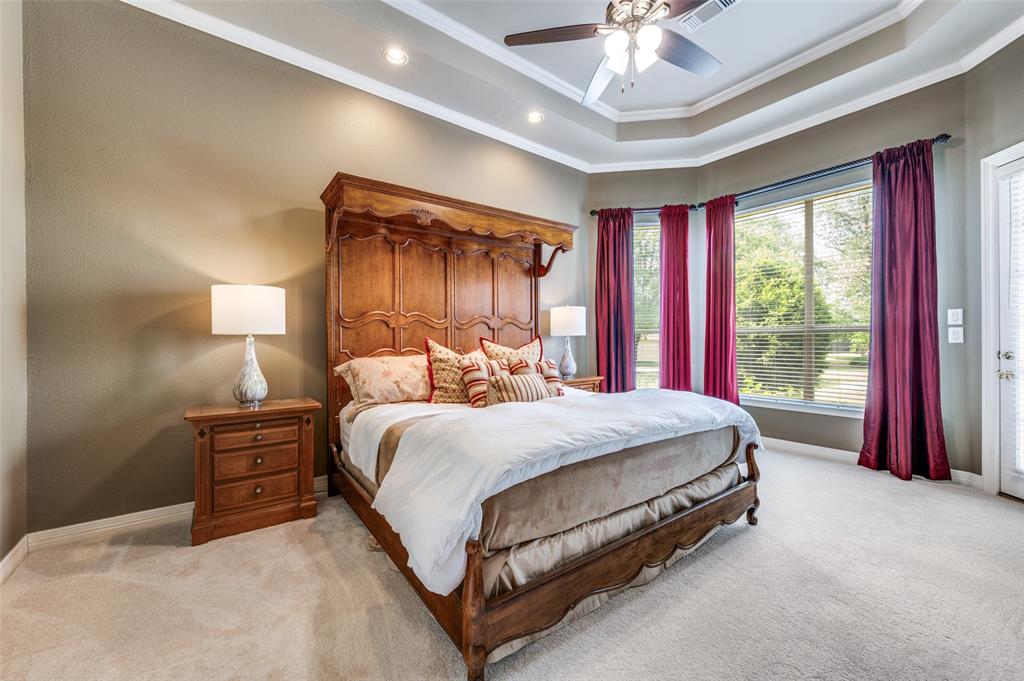 2841 Winding Creek Road Prosper, TX 75078 - Photo 19 of 40 a bed room with a bed and a chandelier