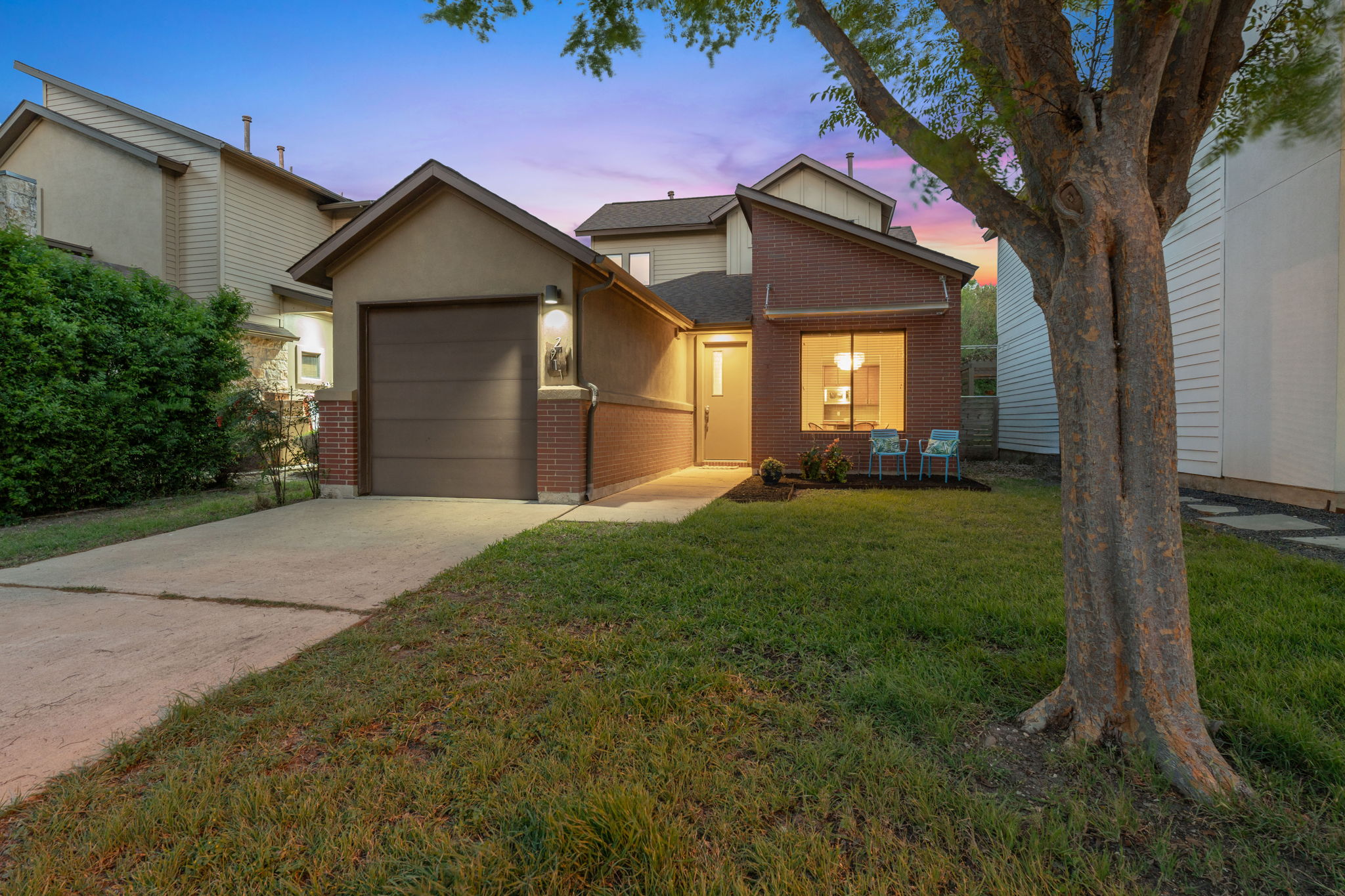a front view of a house with a yard and garage