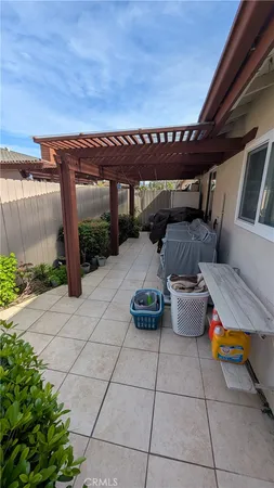 a patio outdoor space with patio furniture and potted plants