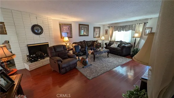 a living room with furniture wooden floor and window