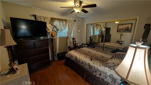 a bedroom with bed and flat screen tv