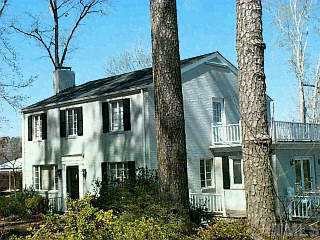 3344 White Oak Road Raleigh, NC 27609 - Photo 1 of 1 a view of a brick house with a large windows and wooden fence