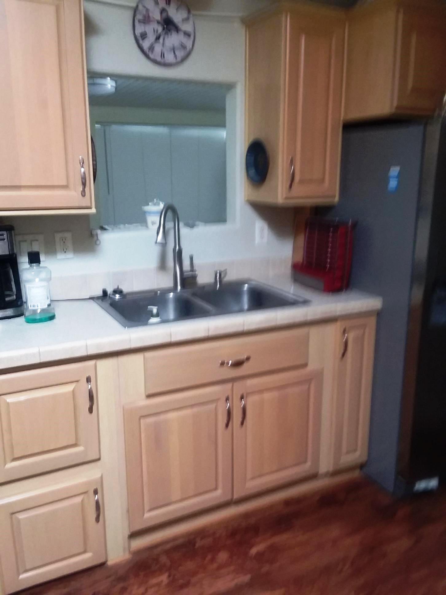 84136 Ave 44, Unit 593 Indio, CA 92203 - Photo 18 of 31 a kitchen with stainless steel appliances granite countertop white cabinets a sink and dishwasher