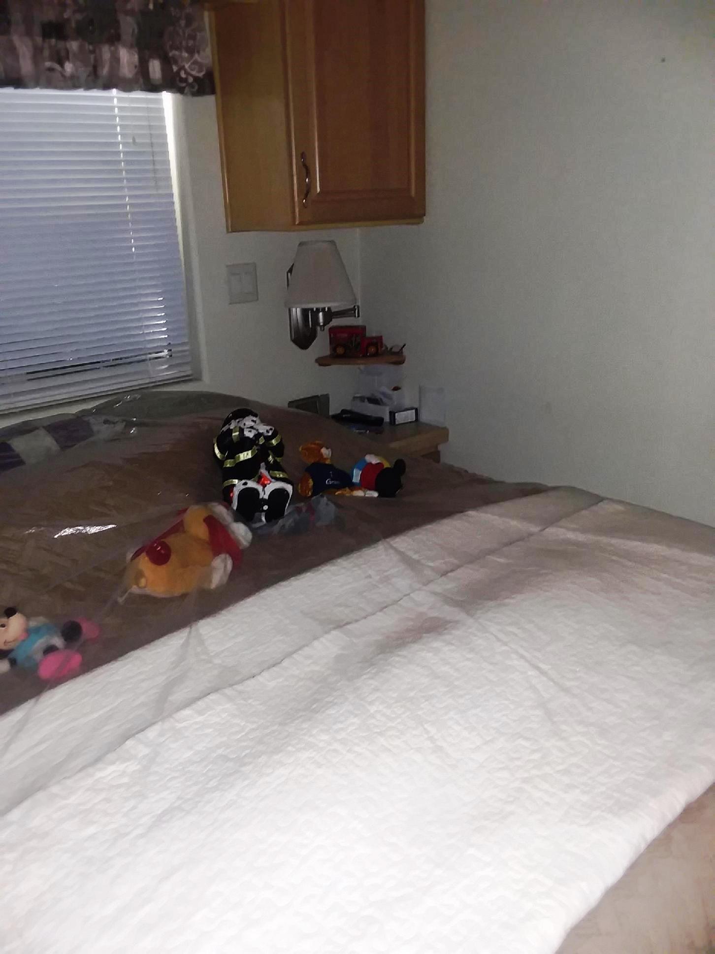 84136 Ave 44, Unit 593 Indio, CA 92203 - Photo 22 of 31 a room with a bed and cabinets