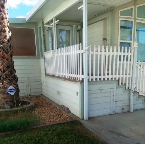 84136 Ave 44, Unit 593 Indio, CA 92203 - Photo 7 of 31 a view of a house with a small yard and wooden fence