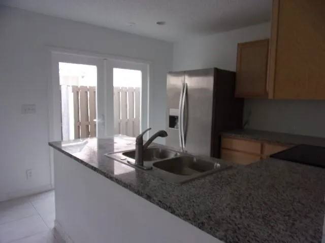 a kitchen with a sink and a refrigerator