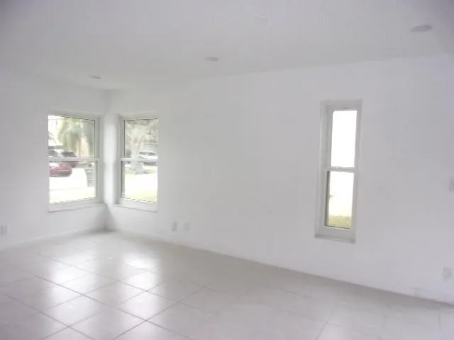 an empty room with windows and closet