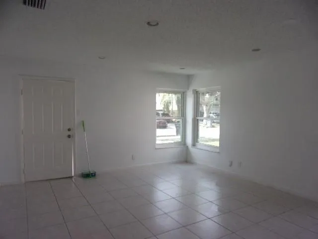 a view of an empty room with windows