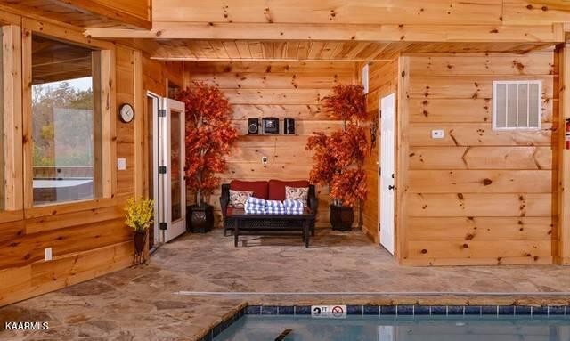 2456 Hackberry Drive Sevierville, TN 37862 - Photo 18 of 25 a view of a brick house with a bench and wooden fence