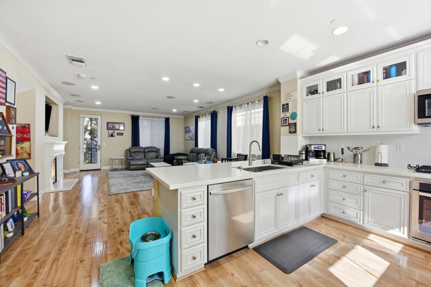 56 Regency Place Hayward, CA 94544 - Photo 14 of 43 a large white kitchen with cabinets a sink a window and stainless steel appliances