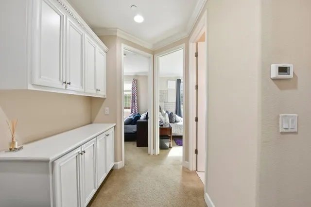 a view of a kitchen with white cabinets
