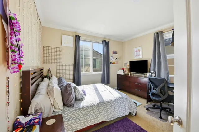 a bedroom with a bed and flat screen tv