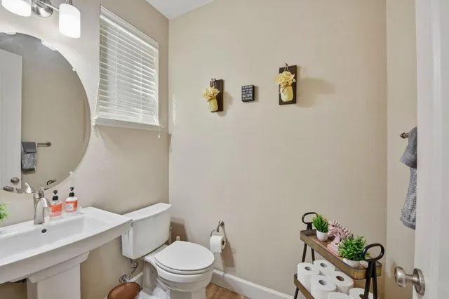a white toilet sitting next to a bathroom sink