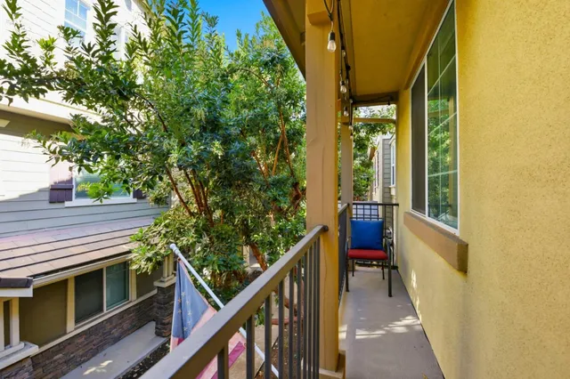 a view of balcony with wooden floor and fence