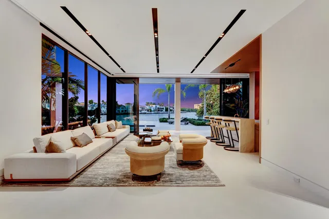 a living room with furniture and a floor to ceiling window