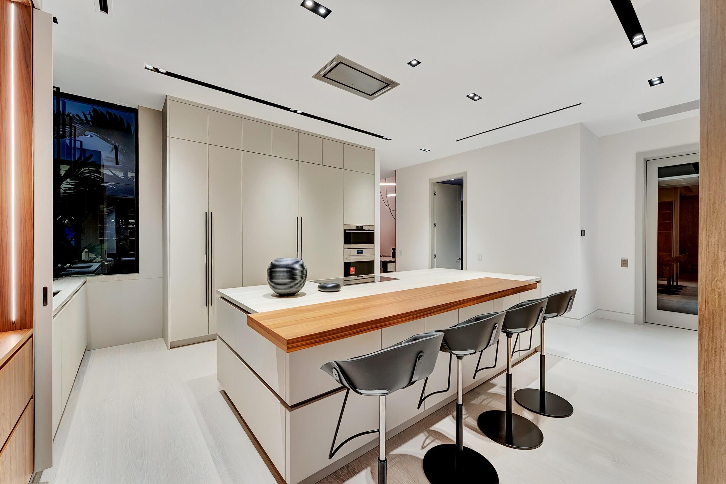 829 Orchid Drive Boca Raton, FL 33432 - Photo 13 of 102 a view of kitchen island with stainless steel appliances kitchen island a table and chairs in it
