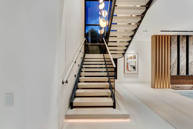 a living room with furniture and large windows