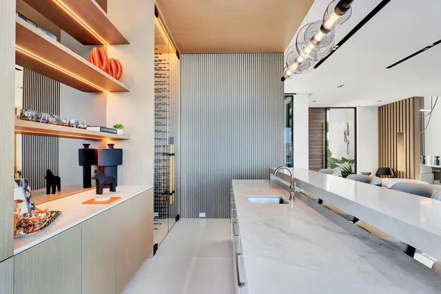 a kitchen with stainless steel appliances kitchen island a large window and cabinets