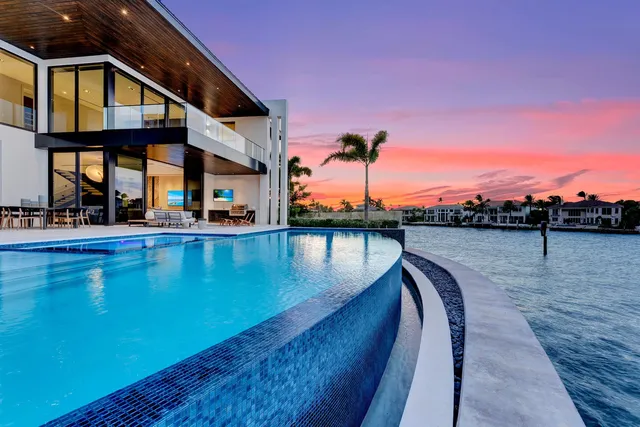 a view of a swimming pool with furniture