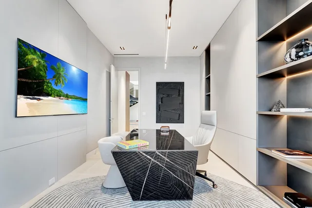 an aerial view of residential houses with outdoor space and ocean view