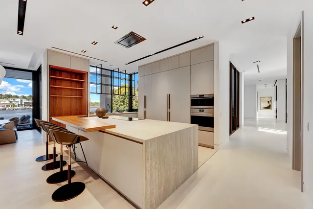 a front view of a house with swimming pool and sitting area