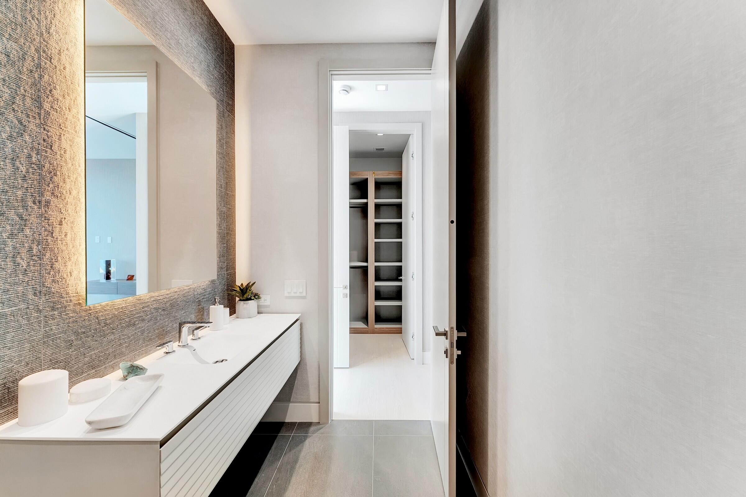 829 Orchid Drive Boca Raton, FL 33432 - Photo 75 of 102 a en suite bathroom with a sink and a mirror