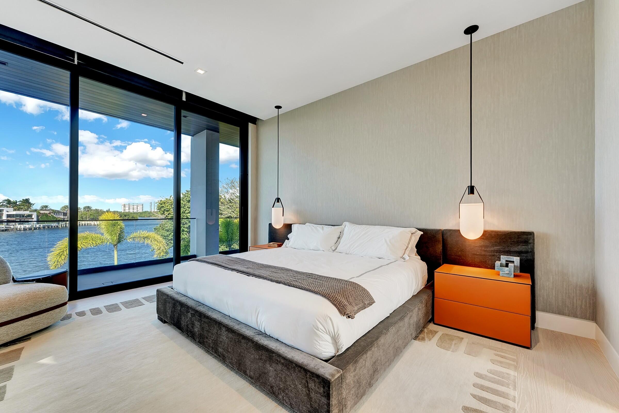 829 Orchid Drive Boca Raton, FL 33432 - Photo 76 of 102 a bedroom with bed and glass door