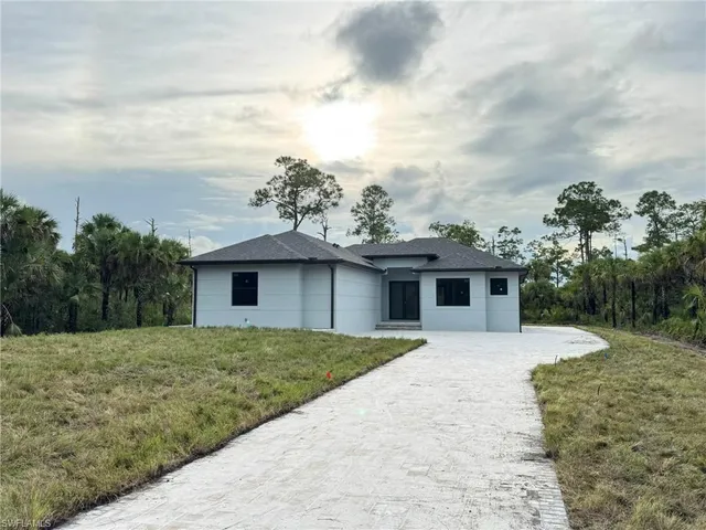a large space with a large window and stainless steel appliances
