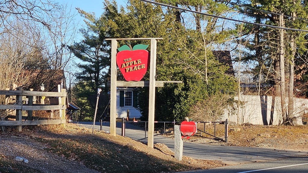 a street sign on a sidewalk next to a building