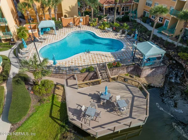 an aerial view of a swimming pool with a patio