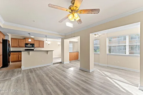 a view of a kitchen with wooden floor and a kitchen space