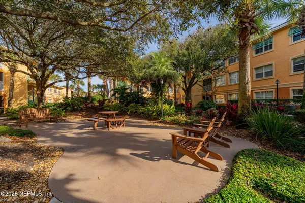 a view of backyard with barbeque grill and outdoor seating