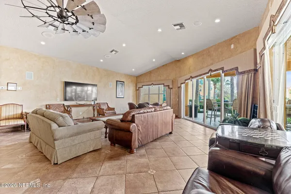 a living room with furniture a dining table and a fireplace