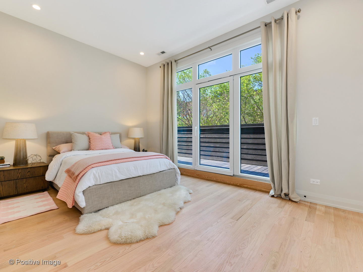 6915 North Western Avenue, Unit 2 Chicago, IL 60645 - Photo 15 of 25 a spacious bedroom with a large bed and a large window