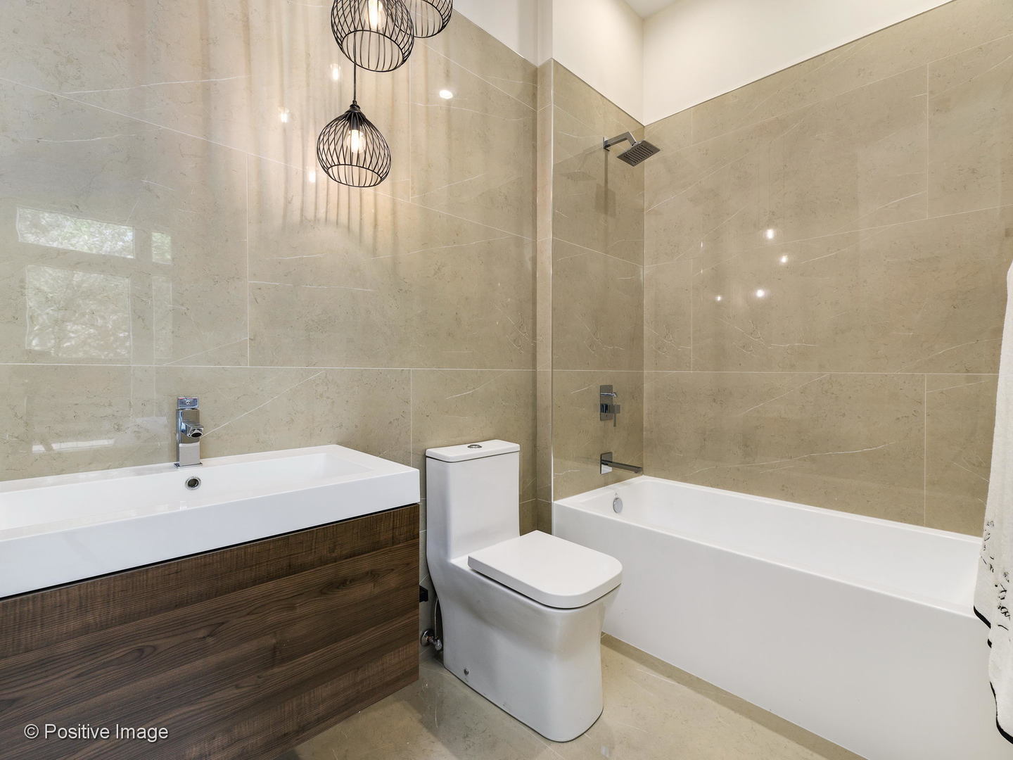 6915 North Western Avenue, Unit 2 Chicago, IL 60645 - Photo 17 of 25 a bathroom with a sink a toilet and a bathtub