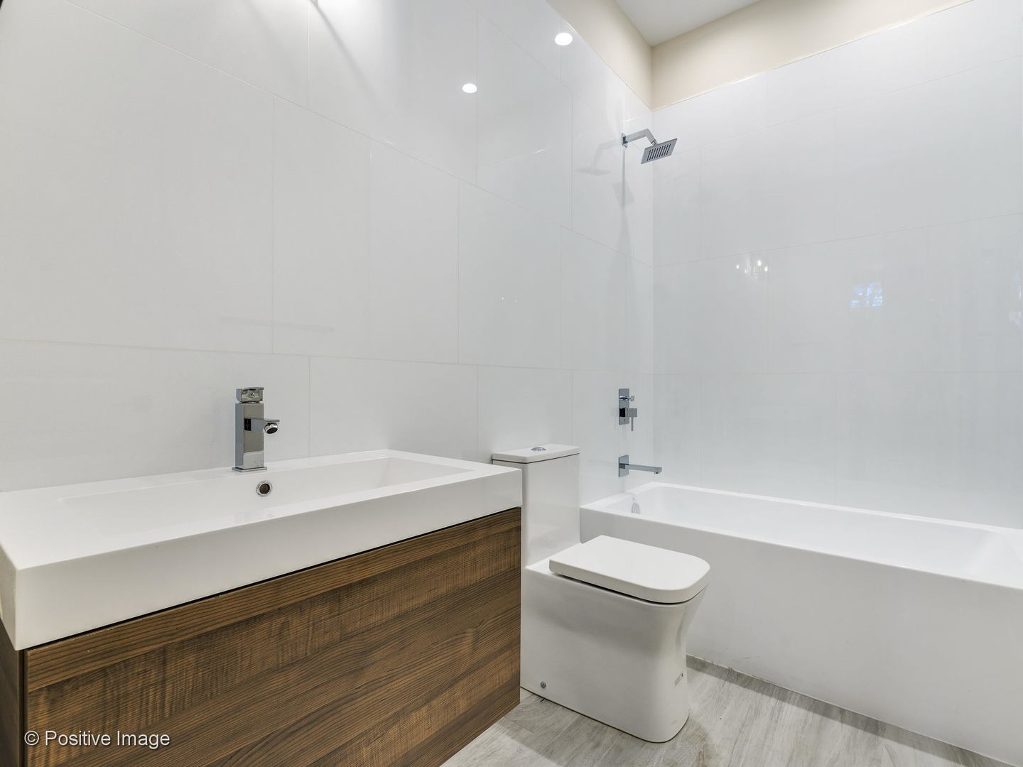 6915 North Western Avenue, Unit 2 Chicago, IL 60645 - Photo 22 of 25 a bathroom with a sink a toilet and a mirror