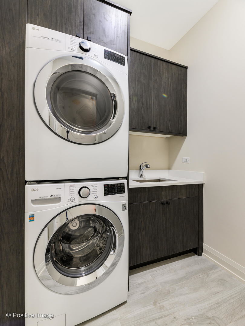 6915 North Western Avenue, Unit 2 Chicago, IL 60645 - Photo 23 of 25 a utility room with sink dryer and washer