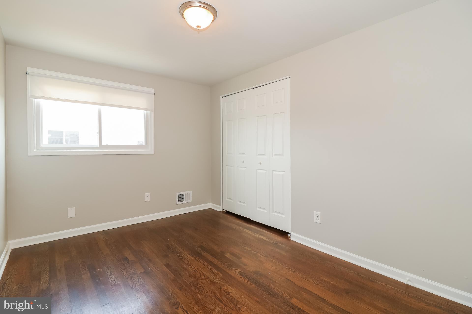 5674 Leiden Road Baltimore, MD 21206 - Photo 11 of 14 an empty room with wooden floor and windows