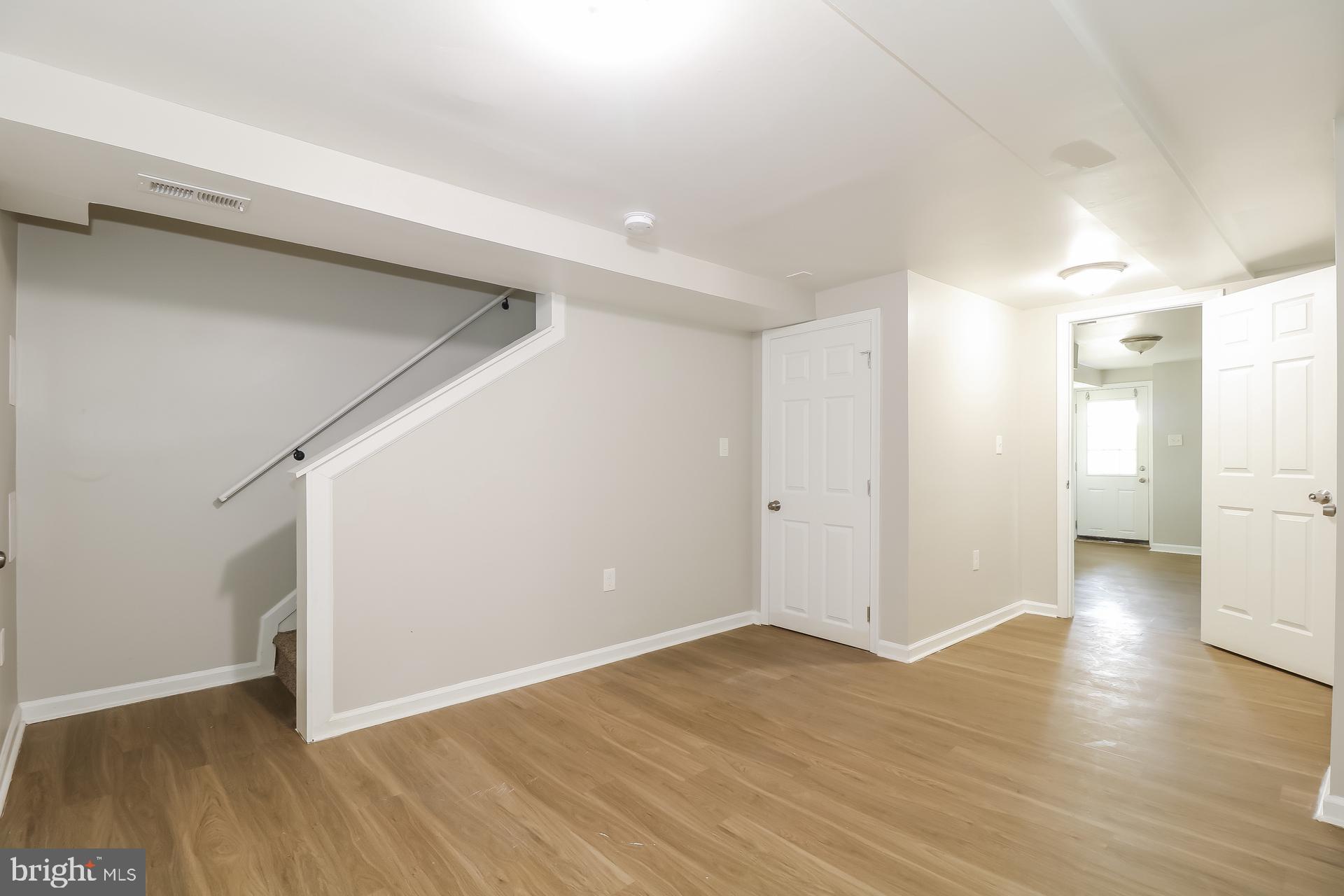 5674 Leiden Road Baltimore, MD 21206 - Photo 13 of 14 a view of a big room with wooden floor and windows