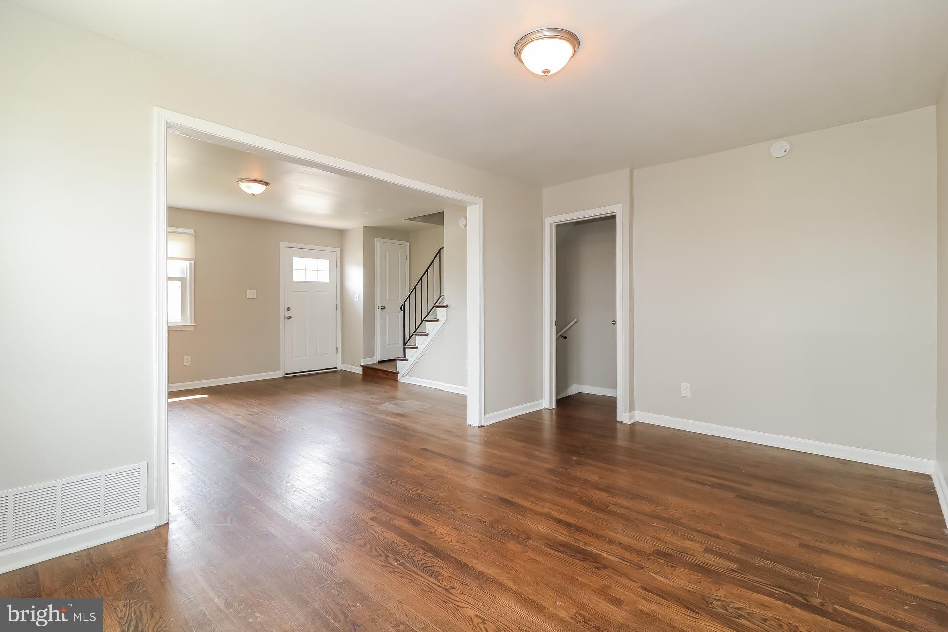5674 Leiden Road Baltimore, MD 21206 - Photo 4 of 14 an empty room with wooden floor and windows