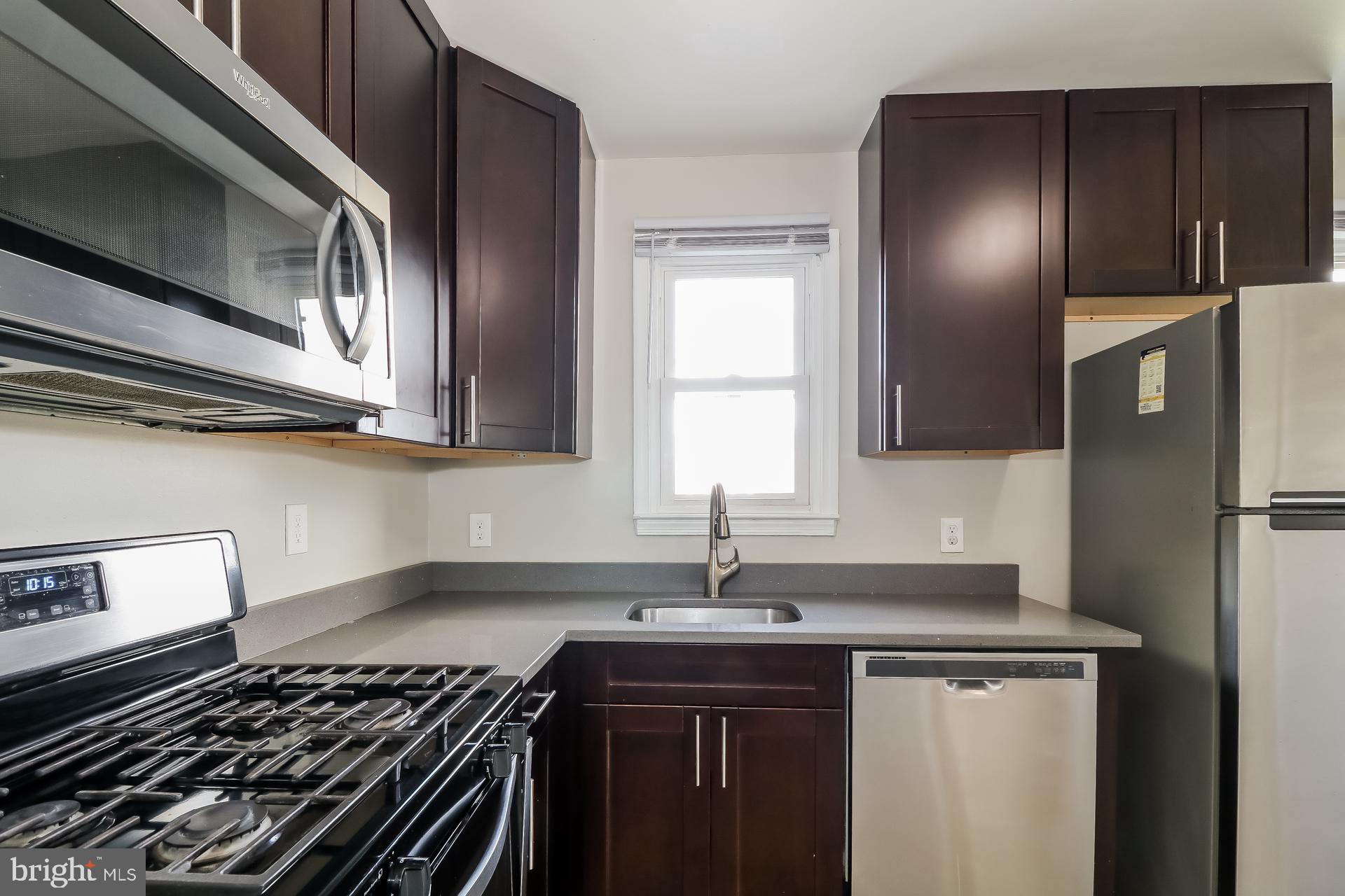 5674 Leiden Road Baltimore, MD 21206 - Photo 6 of 14 a kitchen with a sink and stainless steel appliances