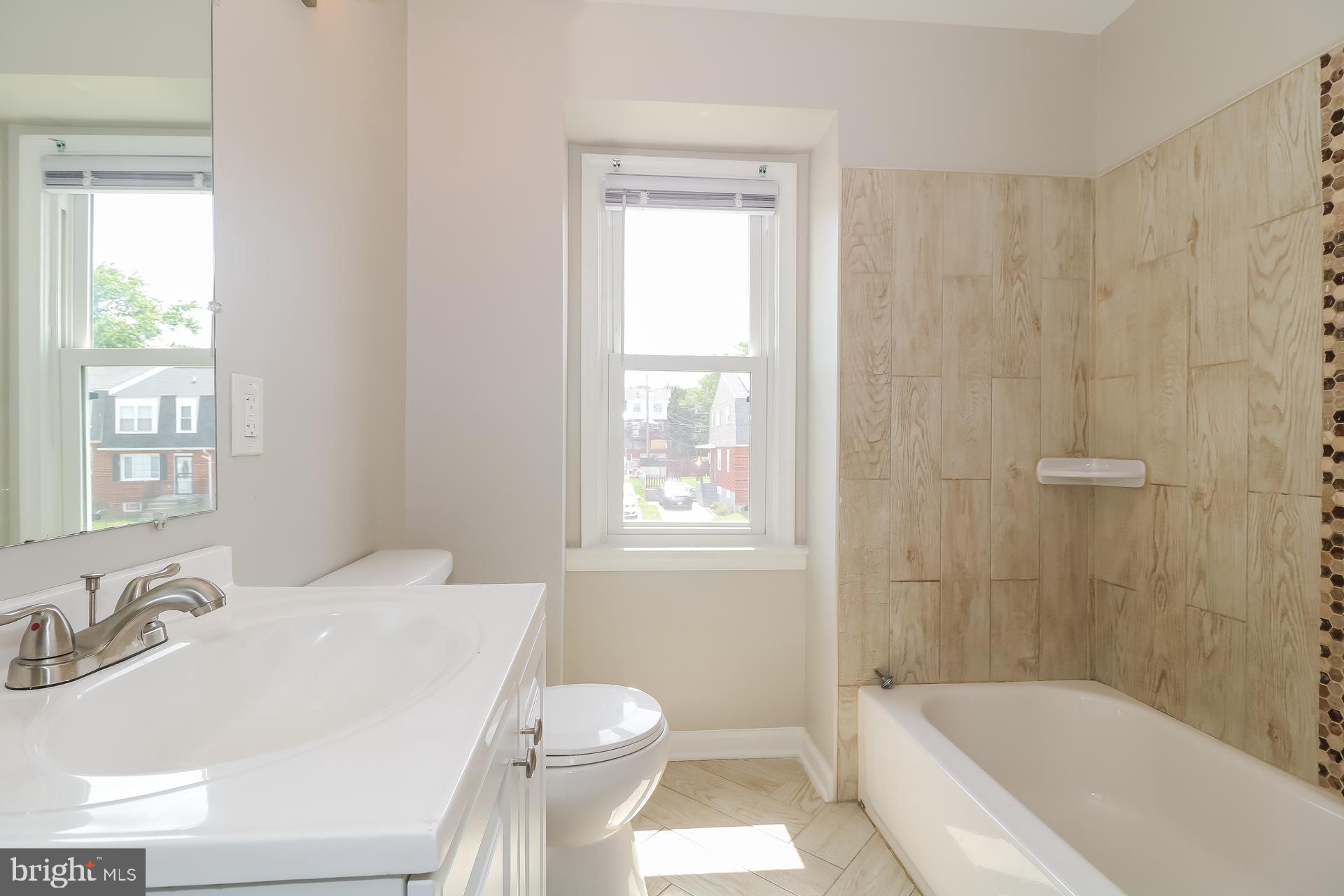5674 Leiden Road Baltimore, MD 21206 - Photo 10 of 14 a bathroom with a sink toilet and shower